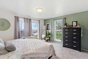 Bedroom with light carpet and baseboards