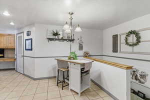 Dining area featuring light tile patterned floors and baseboards
