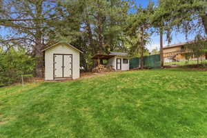 Fenced backyard with a storage shed