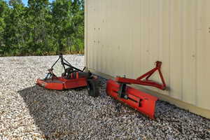 Included brush beater and grader blade for tractor