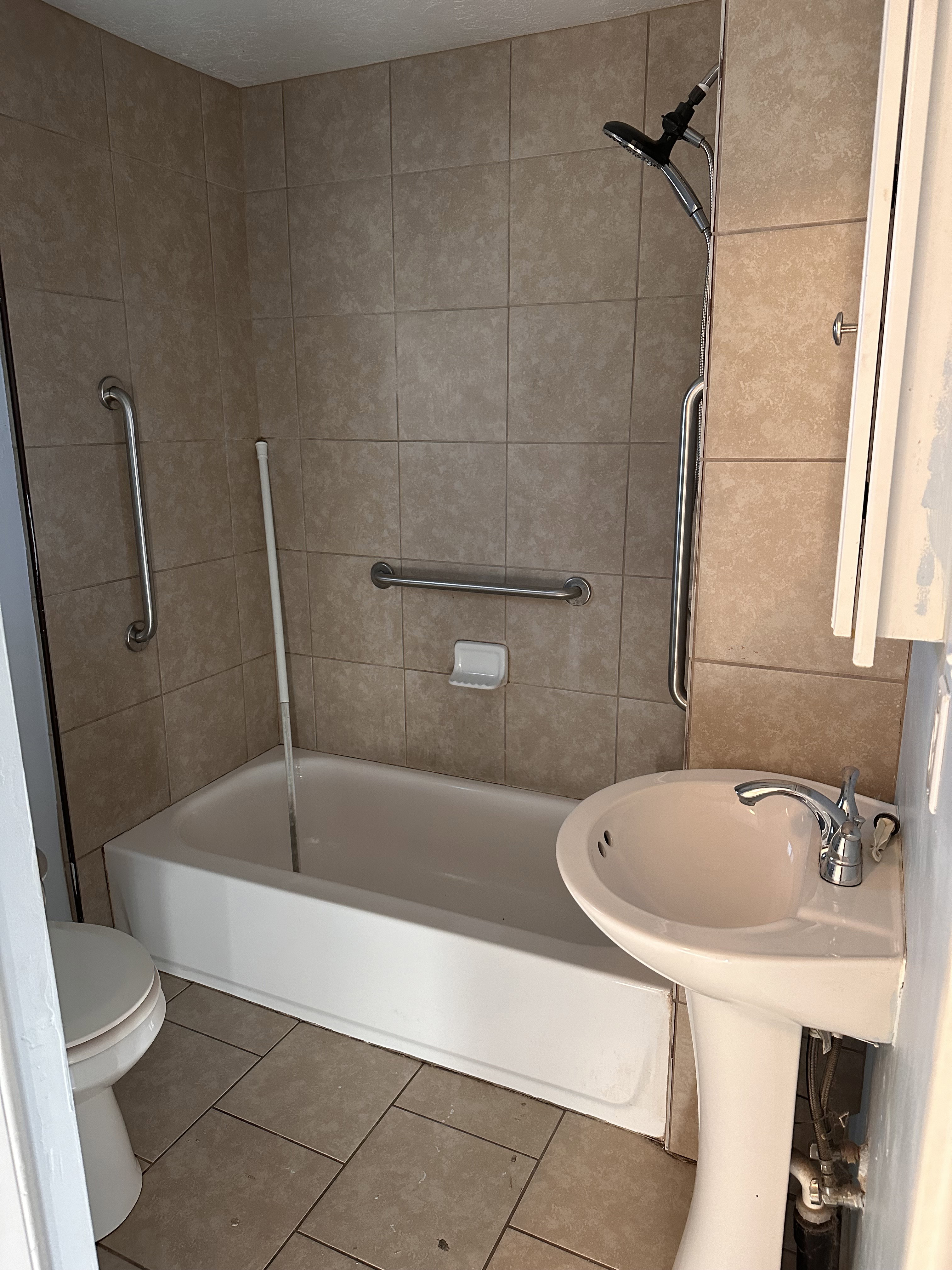 Bathroom featuring tile patterned floors and shower / bathtub combination