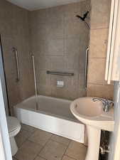 Bathroom featuring tile patterned floors and shower / bathtub combination