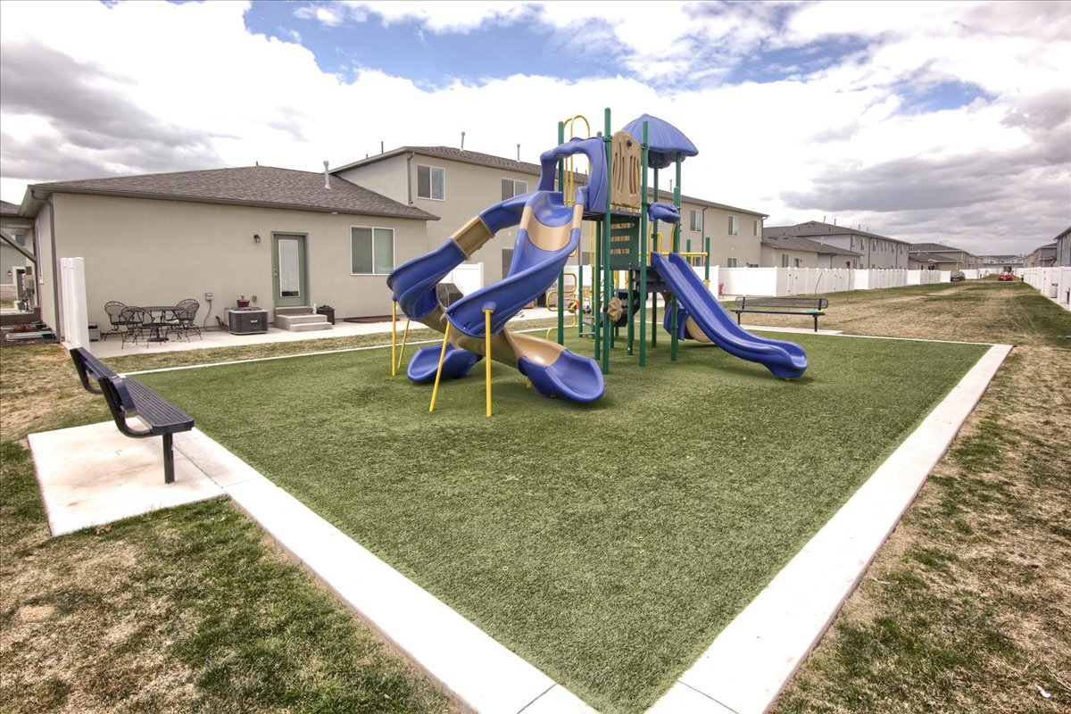 Community jungle gym featuring a patio and a residential view