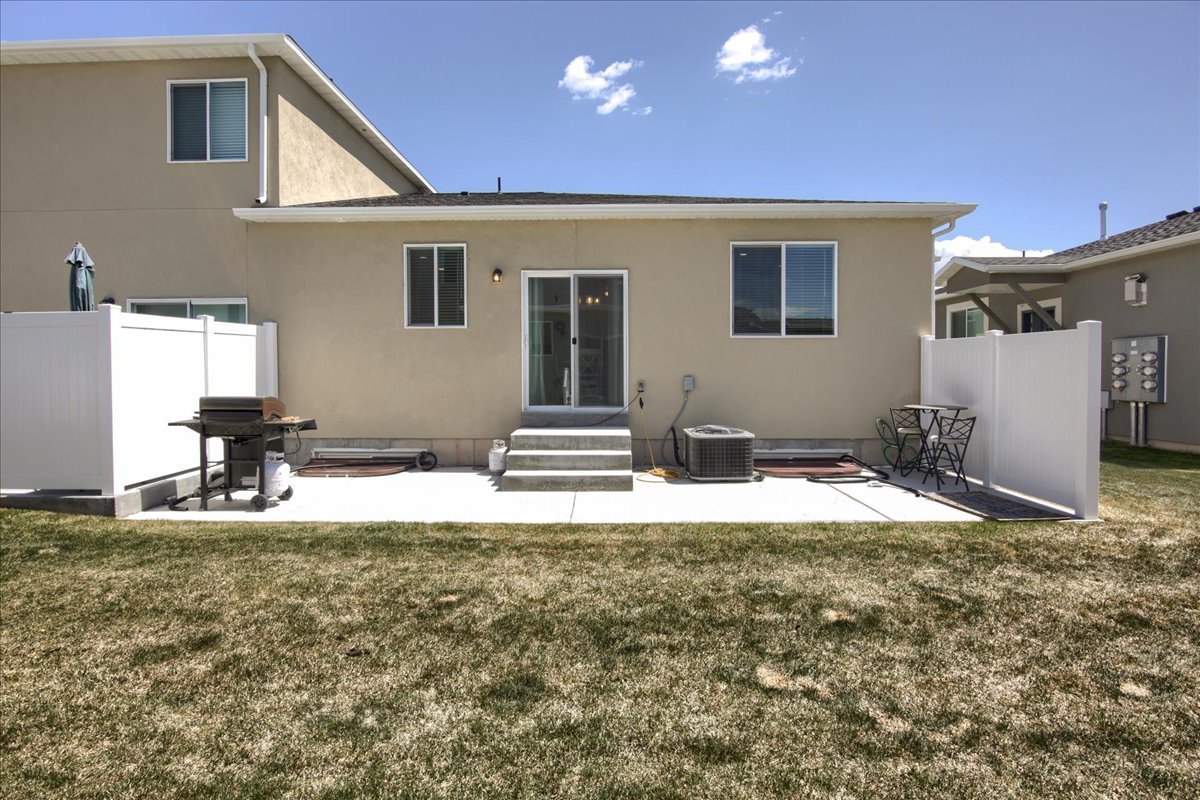 Back of house featuring a patio area, entry steps, and stucco siding
