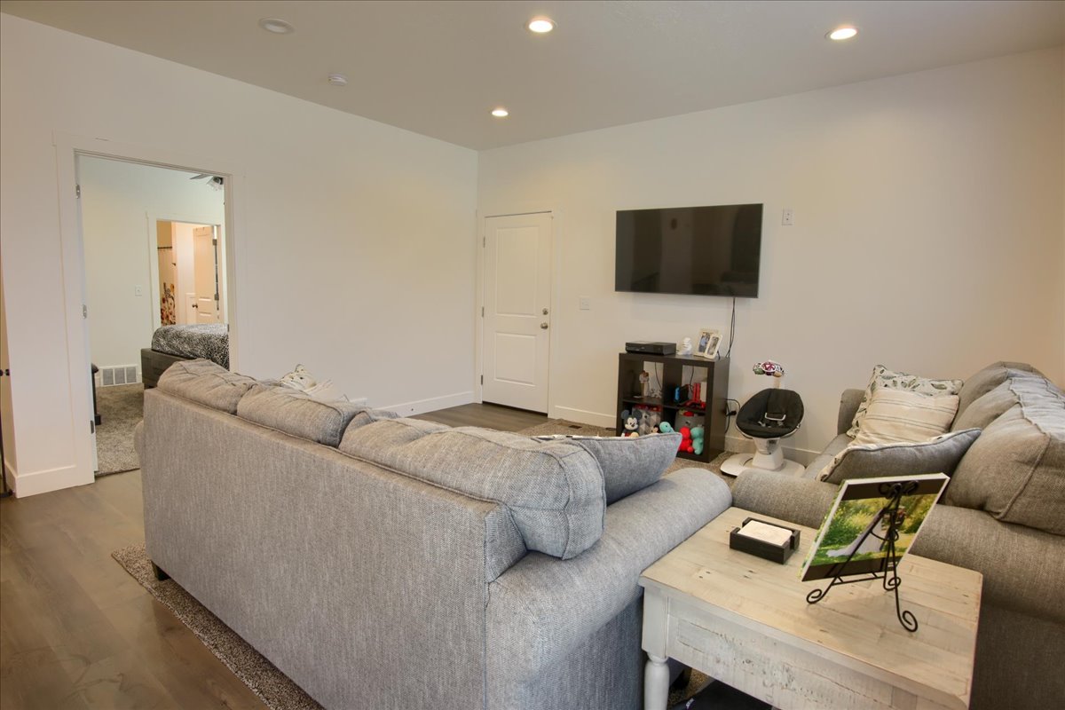 Living area with recessed lighting and wood finished floors