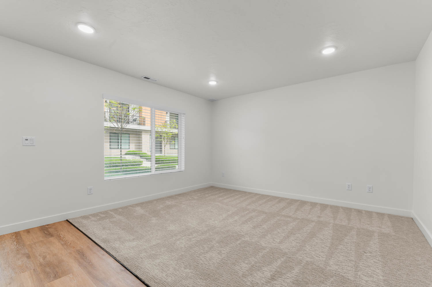 Empty room with recessed lighting and light wood-style floors