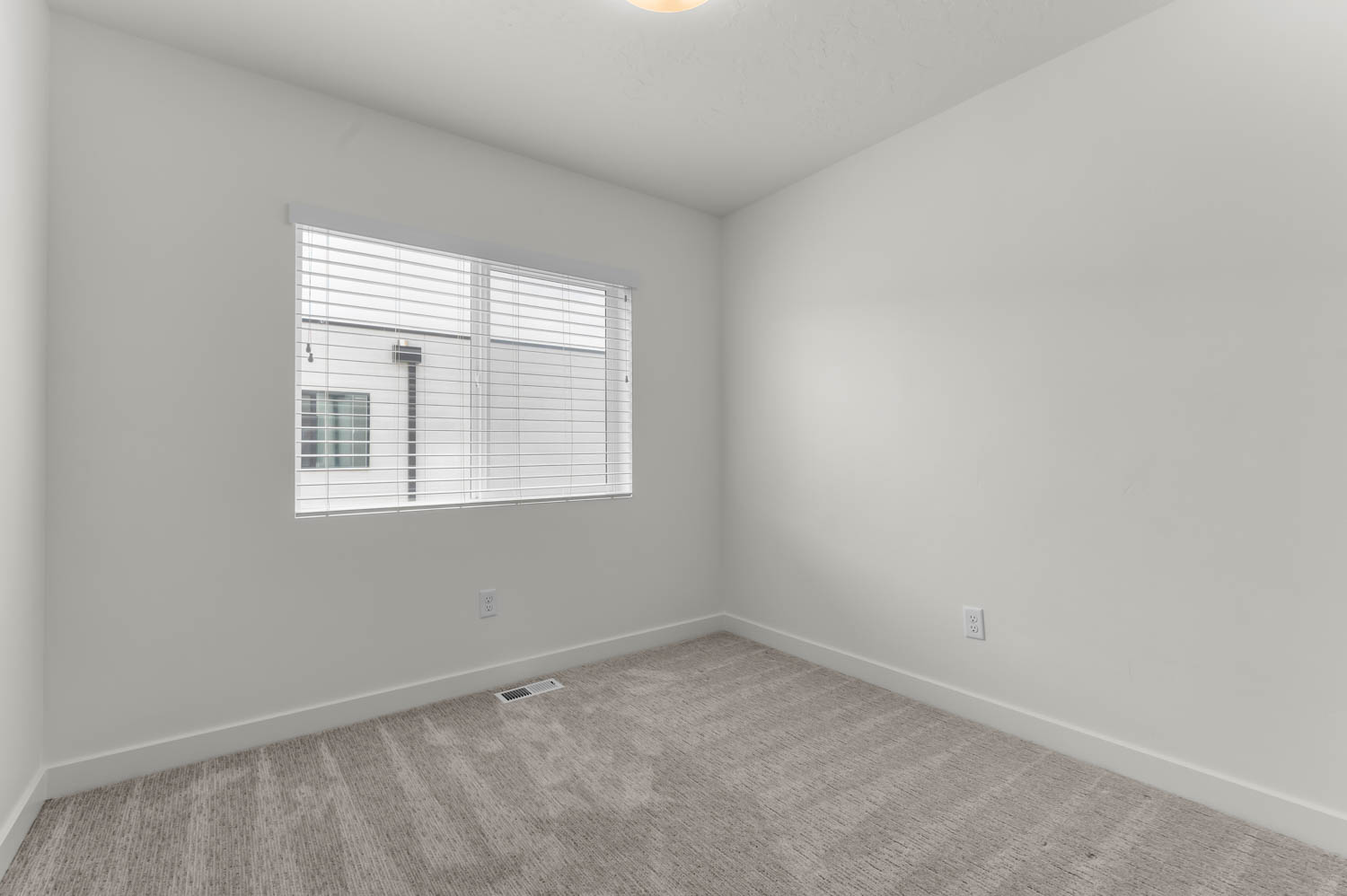 Unfurnished room featuring baseboards and carpet flooring