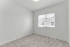 Unfurnished room featuring baseboards and carpet floors
