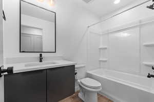 Bathroom featuring vanity, shower / bath combination, and light wood-type flooring