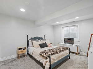 Bedroom featuring light colored carpet and recessed lighting