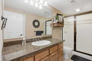 Bathroom with vanity, a shower stall, and light tile patterned floors