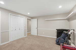Recreation room featuring light carpet and recessed lighting