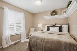 Bedroom featuring carpet floors and baseboards