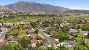 Aerial view of property's location featuring a mountainous background and nearby suburban area