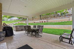 View of patio featuring area for grilling and outdoor dining area