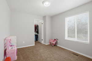 Rec room featuring light carpet and a textured ceiling
