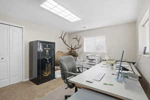 Home office featuring light colored carpet and baseboards