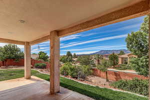Fenced backyard featuring a mountain view and a patio area