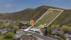 Aerial perspective of suburban area featuring mountains and property boundaries highlighted