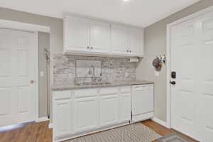 Laundry area featuring a sink and light wood-type flooring