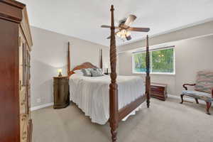 Bedroom featuring ceiling fan and light carpet