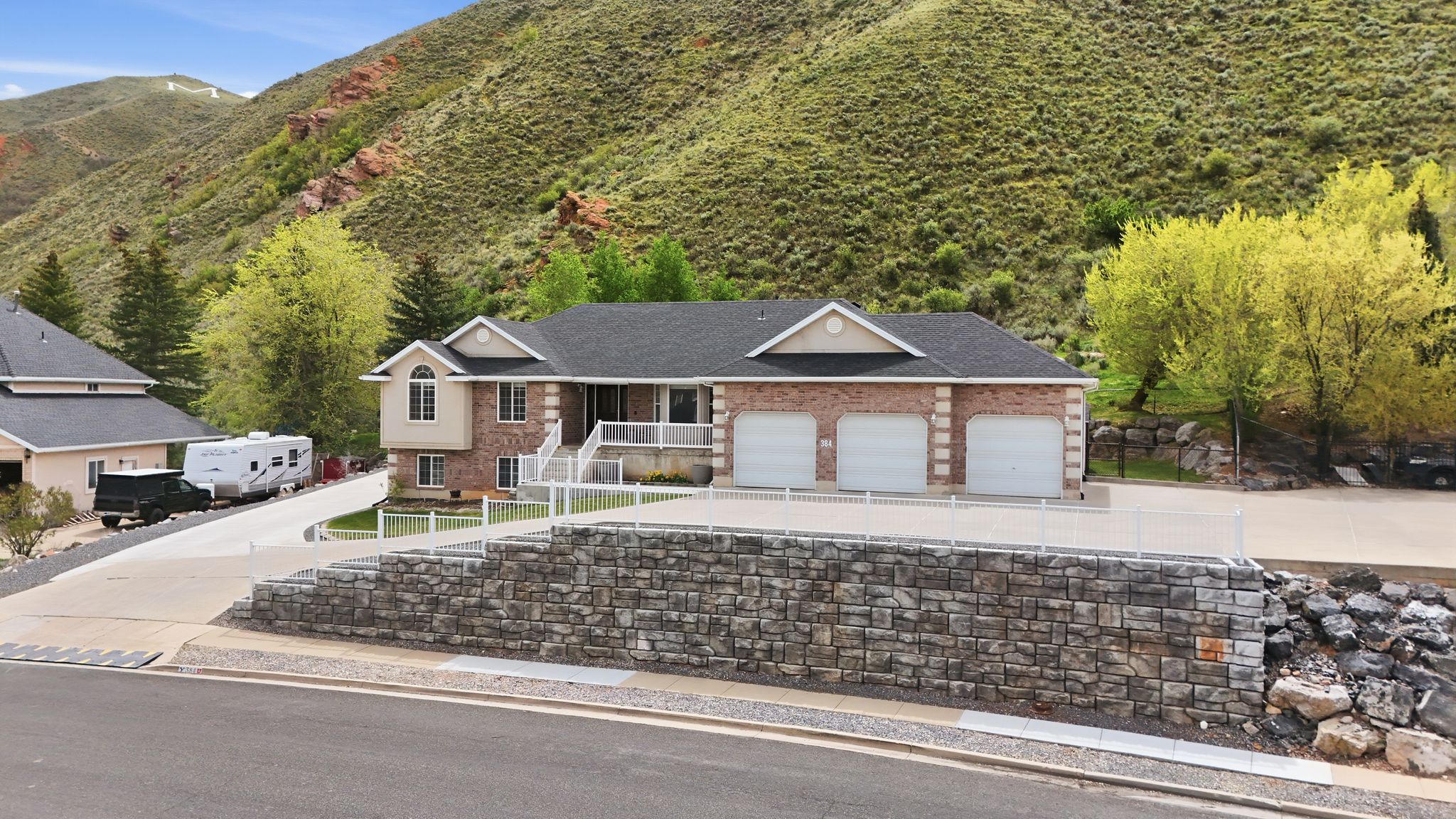 Single story home with a garage, covered porch, concrete driveway, and brick siding