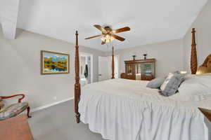 Bedroom featuring dark carpet and a ceiling fan