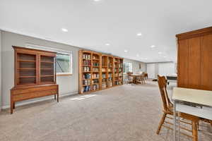 Office with light colored carpet and recessed lighting