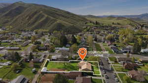 Aerial view of property and surrounding area with property boundaries highlighted and nearby suburban area