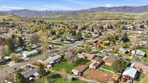 Aerial overview of property's location featuring a mountainous background and nearby suburban area
