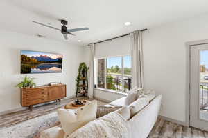 Living room featuring a ceiling fan, light wood finished floors, and recessed lighting