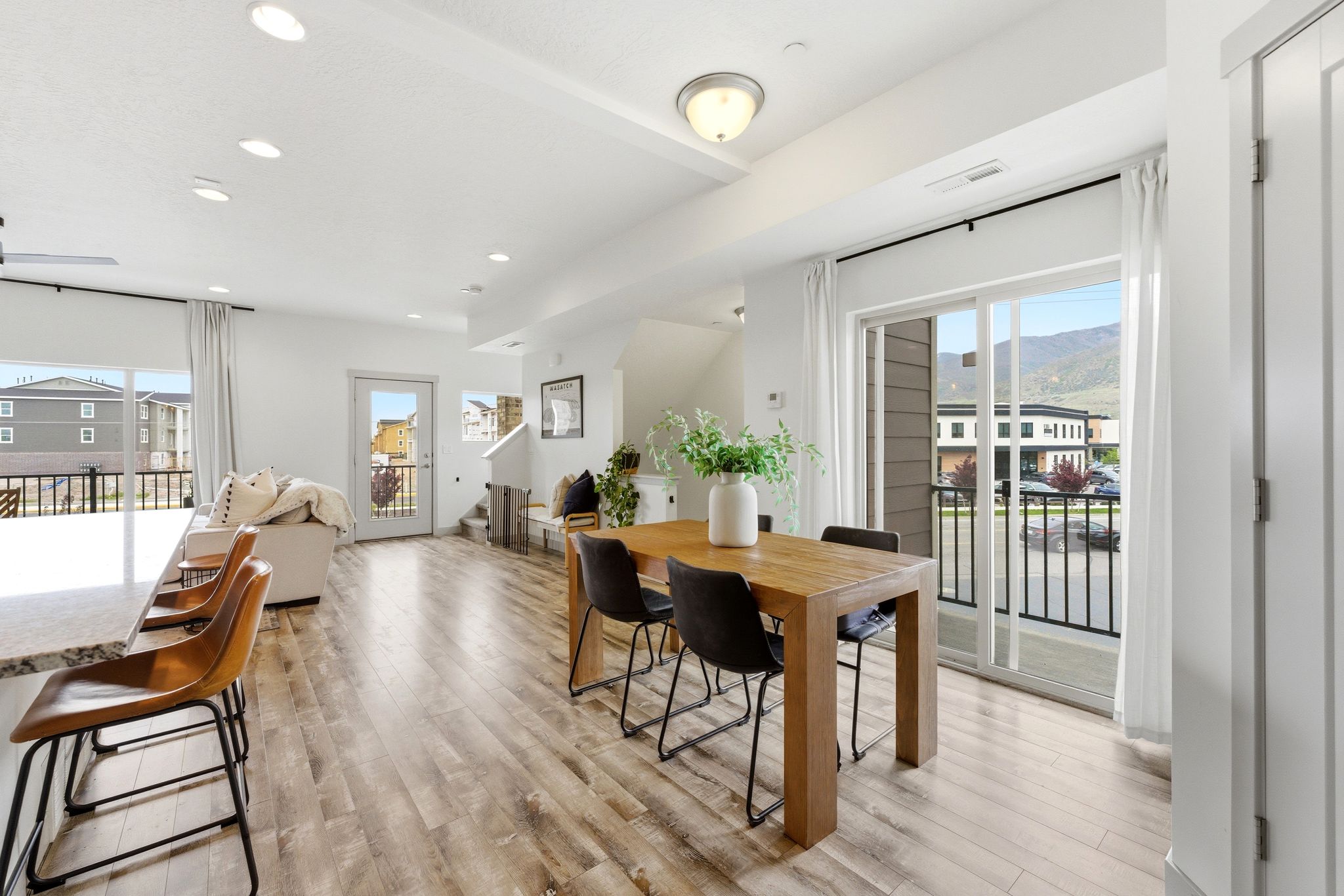 Dining area featuring plenty of natural light, light wood-style floors, recessed lighting, and a mountain view