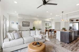 Living area featuring ceiling fan, light wood-type flooring, and recessed lighting