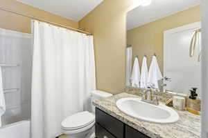 Bathroom with vanity and shower / tub combo with curtain
