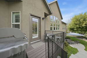 Wooden deck featuring grilling area and outdoor lounge area