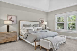 Bedroom featuring light carpet and baseboards