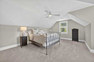Bedroom featuring light carpet, vaulted ceiling, and ceiling fan