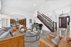 Living area with arched walkways, plenty of natural light, recessed lighting, and lofted ceiling
