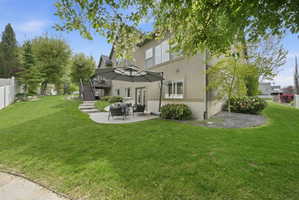 Back of property with a patio and stucco siding