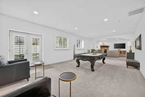 Rec room with recessed lighting, light colored carpet, billiards table, french doors, and a fireplace