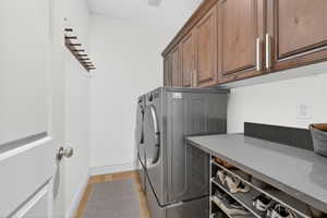 Laundry area with cabinet space and washing machine and clothes dryer