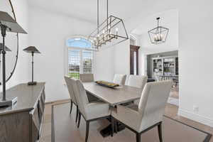 Dining room with a high ceiling and a chandelier