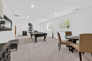 Playroom featuring light colored carpet, recessed lighting, arched walkways, and billiards