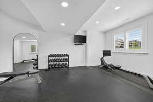 Workout area featuring recessed lighting and a textured ceiling