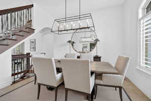 Dining room featuring a chandelier, arched walkways, and light tile patterned flooring