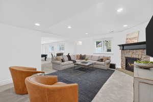 Carpeted living area with plenty of natural light, recessed lighting, arched walkways, a fireplace, and billiards