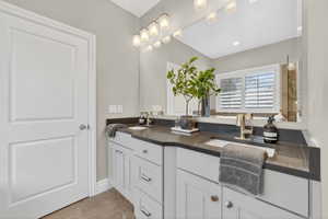 Bathroom with double vanity and light tile patterned flooring
