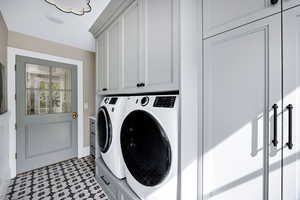 Laundry room featuring cabinet space and washer and clothes dryer