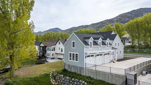 Rear view of property with a garage, a mountain view, and driveway