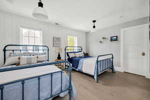 Bedroom featuring wood finished floors and baseboards